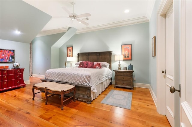 bedroom with a ceiling fan, crown molding, wood finished floors, and baseboards