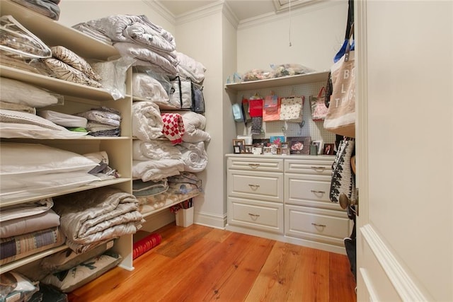 spacious closet with attic access and light wood finished floors