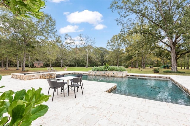 pool featuring a patio, a lawn, and an in ground hot tub