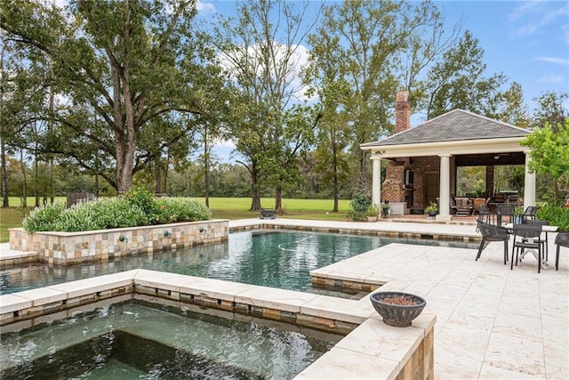 pool with a gazebo, a patio, and an in ground hot tub