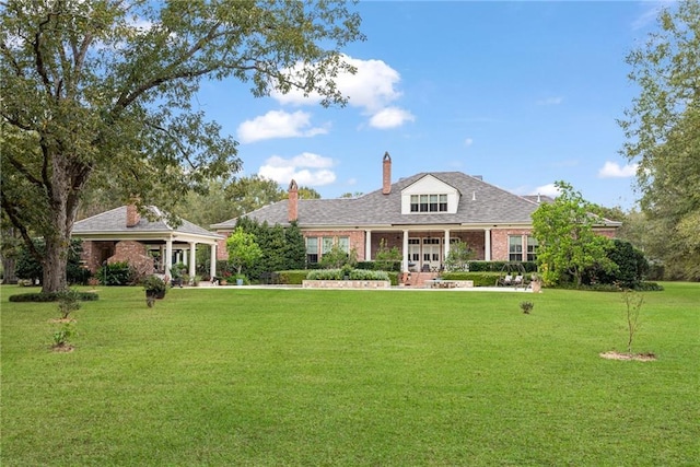 view of front of home featuring a front yard and brick siding