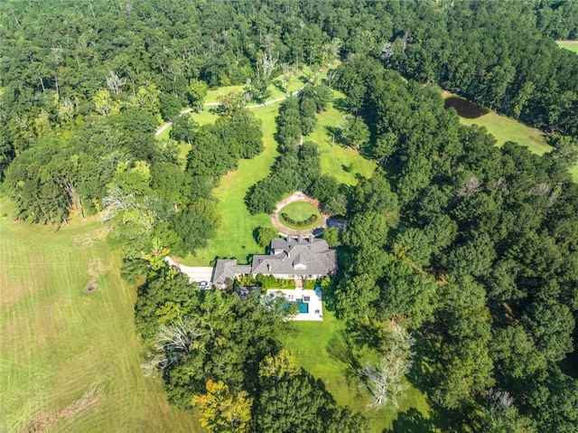 drone / aerial view featuring a wooded view