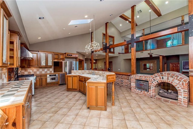 500 W Willow St, Ponchatoula, LA 70454 - kitchen with backsplash, a skylight, a kitchen island, and high vaulted ceiling