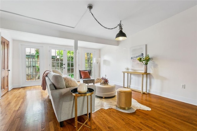 sitting room with french doors and hardwood / wood-style flooring