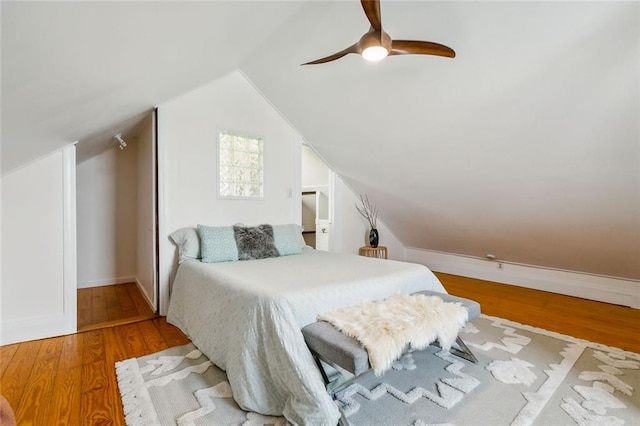 bedroom with wood-type flooring, vaulted ceiling, and ceiling fan