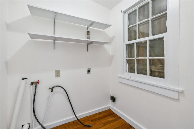 washroom featuring hookup for a washing machine, dark hardwood / wood-style floors, and electric dryer hookup