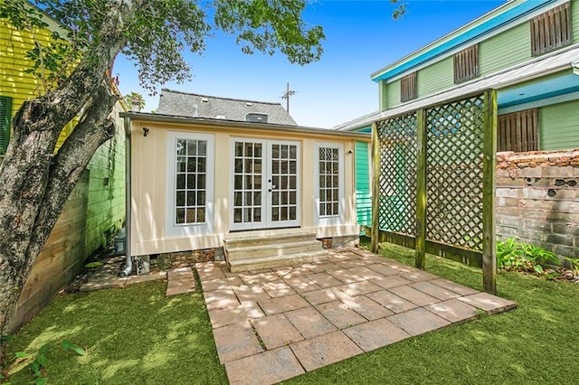 rear view of property with a patio and a lawn