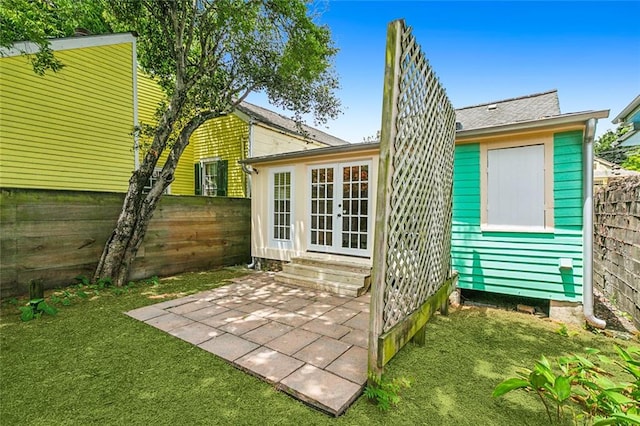 back of property with a lawn and a patio area