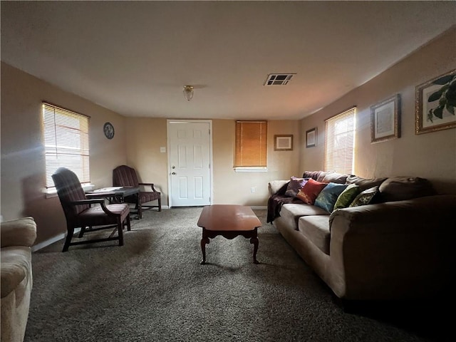 living room featuring carpet floors and a healthy amount of sunlight