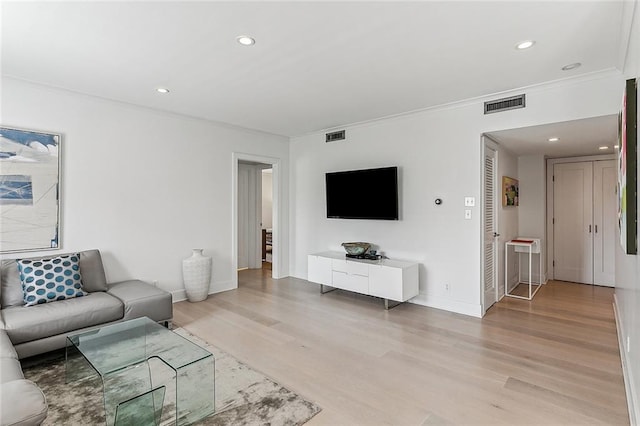 living room with ornamental molding and hardwood / wood-style floors