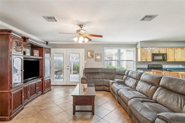 living room with ornamental molding, light tile patterned floors, and french doors