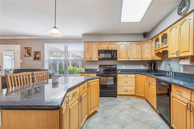 kitchen with a center island, dark stone counters, black appliances, sink, and hanging light fixtures