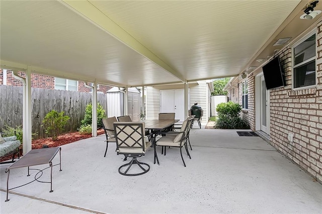 view of patio / terrace featuring a storage unit