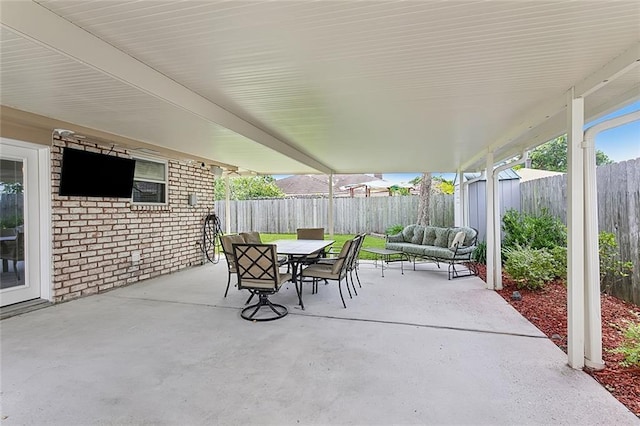 view of patio featuring a storage unit