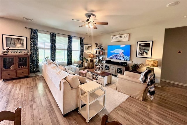 living room with ceiling fan and hardwood / wood-style flooring