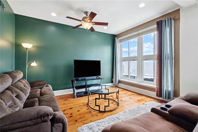 living room featuring ceiling fan and light hardwood / wood-style floors