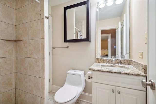 bathroom with vanity, toilet, and tile patterned flooring