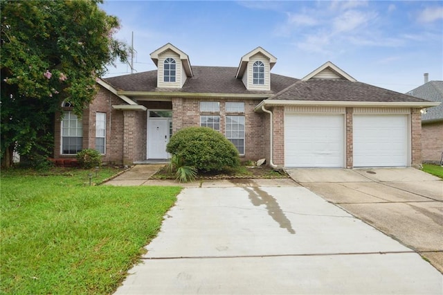 view of front of house with a front yard and a garage