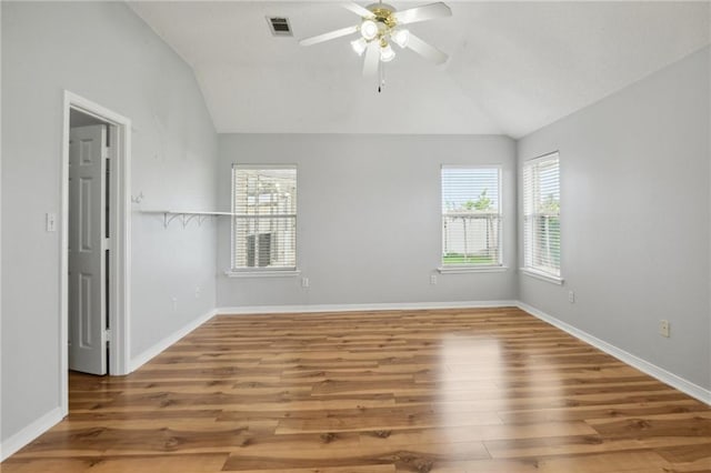 unfurnished room featuring lofted ceiling, wood-type flooring, and ceiling fan