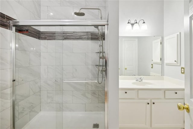 bathroom featuring walk in shower and vanity