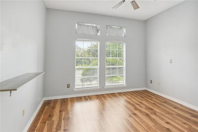 spare room with ceiling fan and hardwood / wood-style flooring