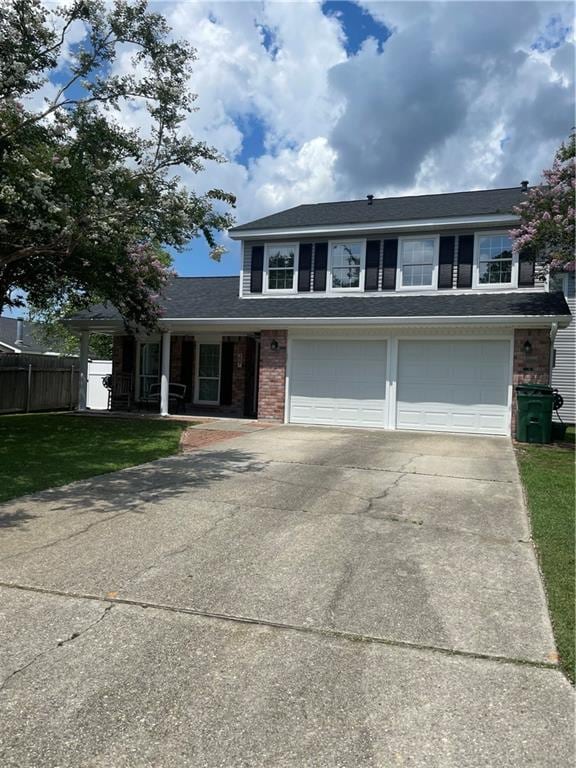 view of front of property with a garage and a front yard