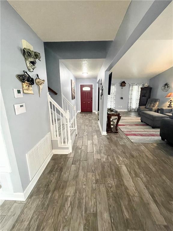 corridor featuring wood-type flooring