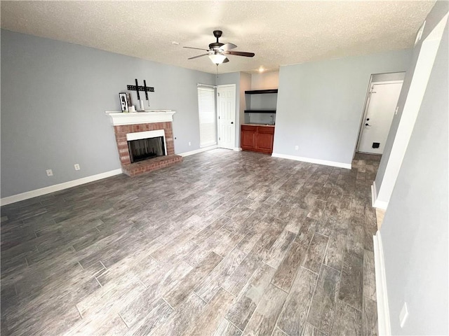 unfurnished living room featuring hardwood / wood-style flooring, a fireplace, a textured ceiling, and ceiling fan