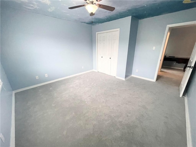 unfurnished bedroom with a closet, carpet, and ceiling fan