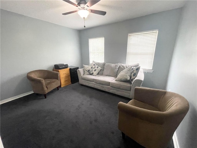 carpeted living room featuring a textured ceiling and ceiling fan