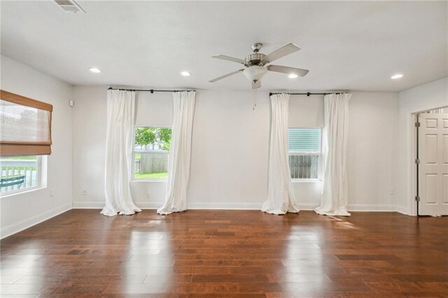 empty room featuring dark wood-type flooring and ceiling fan