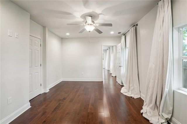 spare room with dark wood-type flooring and ceiling fan