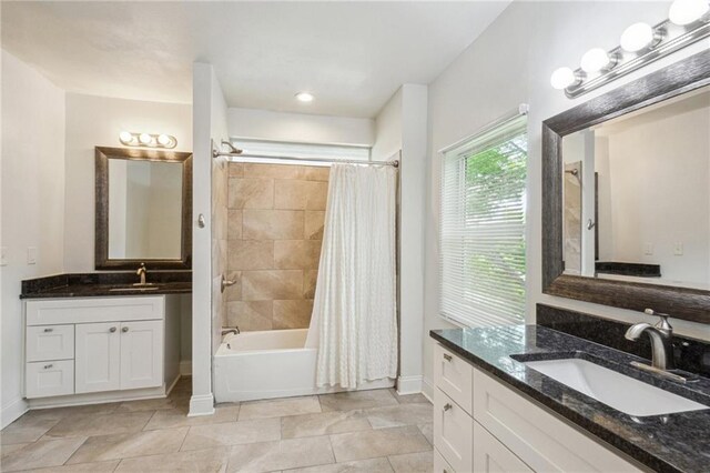 bathroom with shower / bath combo with shower curtain, vanity, and tile patterned floors