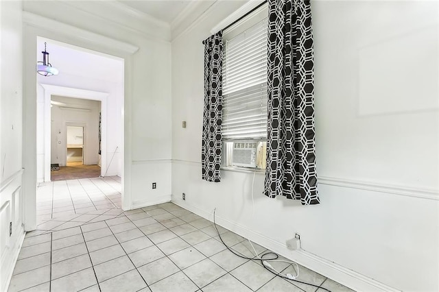 tiled spare room with cooling unit and ornamental molding