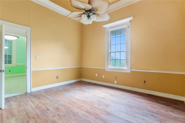 unfurnished room featuring crown molding, light hardwood / wood-style flooring, and ceiling fan