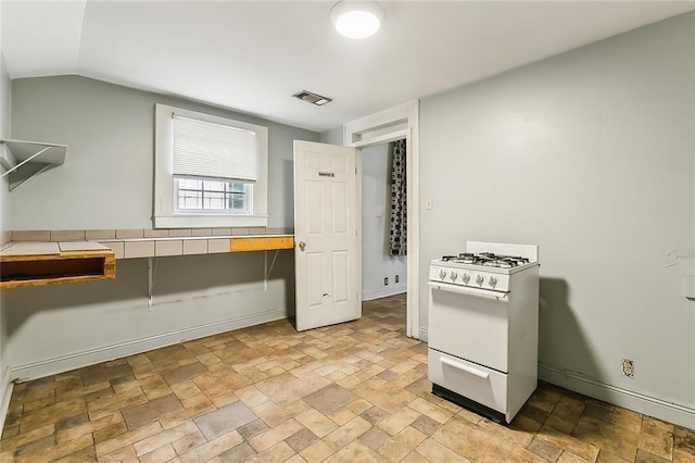 kitchen with vaulted ceiling and white range with gas stovetop