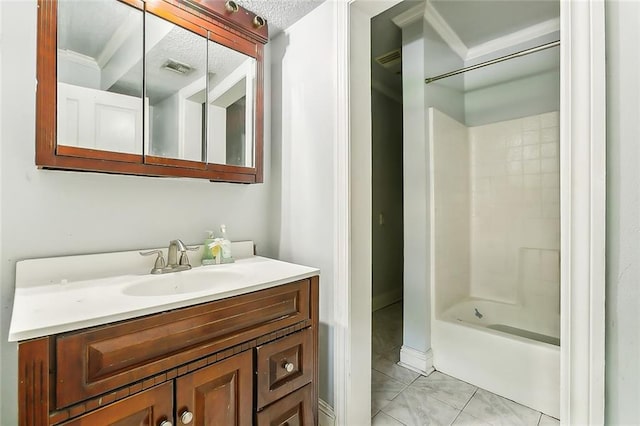 bathroom featuring shower / washtub combination, vanity, and a textured ceiling