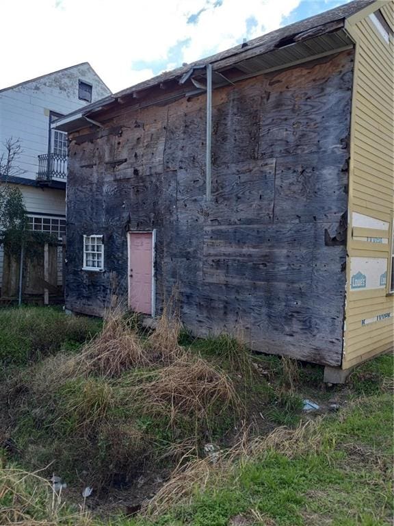 view of side of property with a balcony