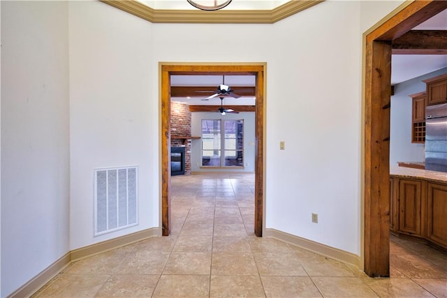 corridor featuring light tile patterned floors, crown molding, and beam ceiling