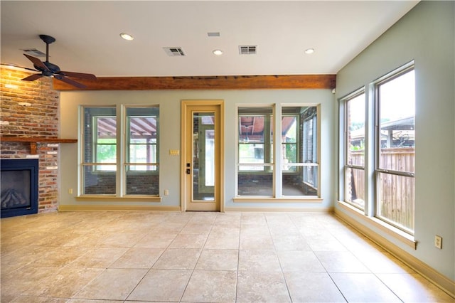 unfurnished living room featuring light tile patterned floors, ceiling fan, and a brick fireplace