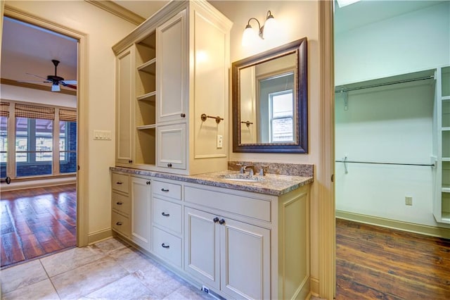 bathroom featuring ceiling fan, vanity, hardwood / wood-style floors, and a wealth of natural light