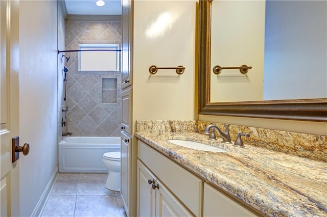 full bathroom with tile patterned flooring, tiled shower / bath, vanity, and toilet