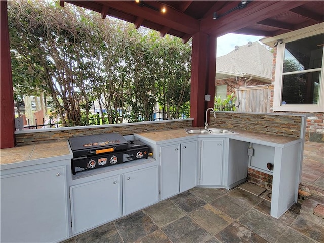 view of patio / terrace with area for grilling, sink, and exterior kitchen