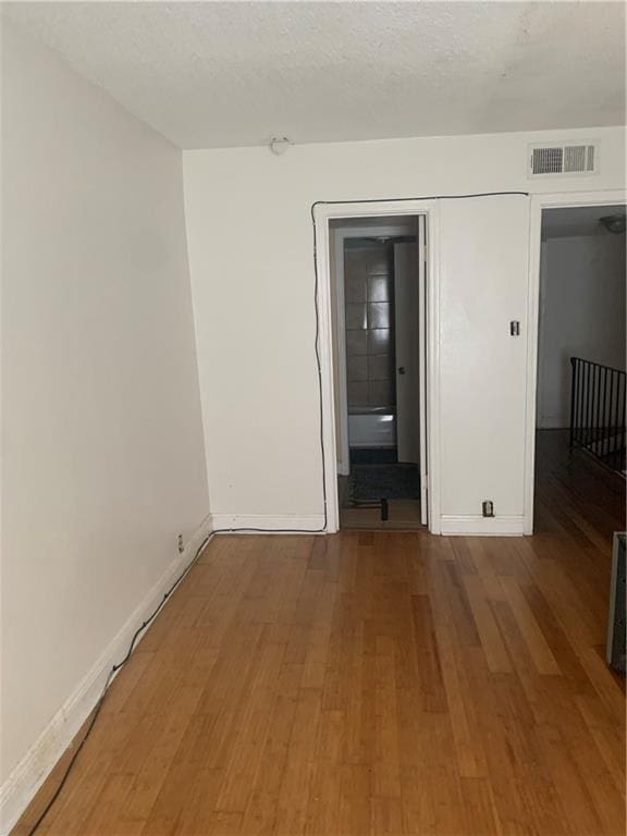 spare room with wood-type flooring