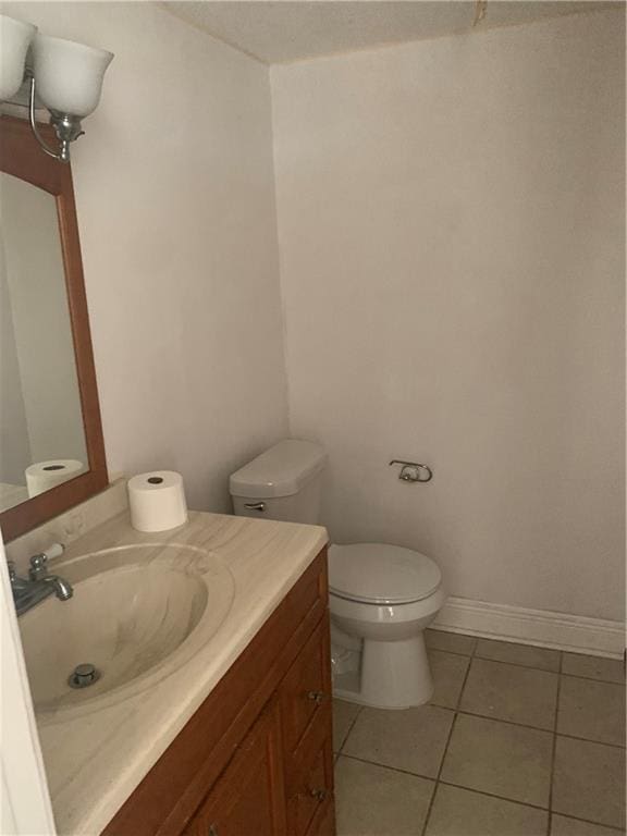 bathroom with vanity, tile patterned floors, and toilet