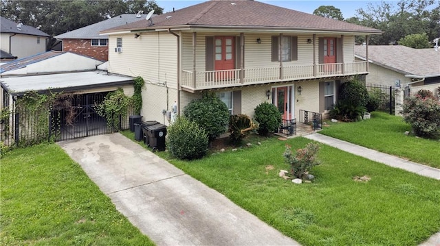 view of front of property with a balcony and a front yard