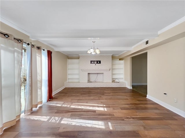 unfurnished living room with hardwood / wood-style floors, beamed ceiling, built in features, brick wall, and a brick fireplace