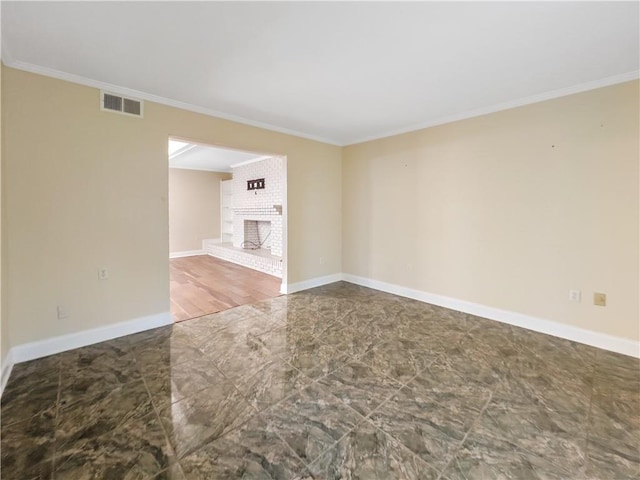 tiled empty room with a fireplace, crown molding, and brick wall