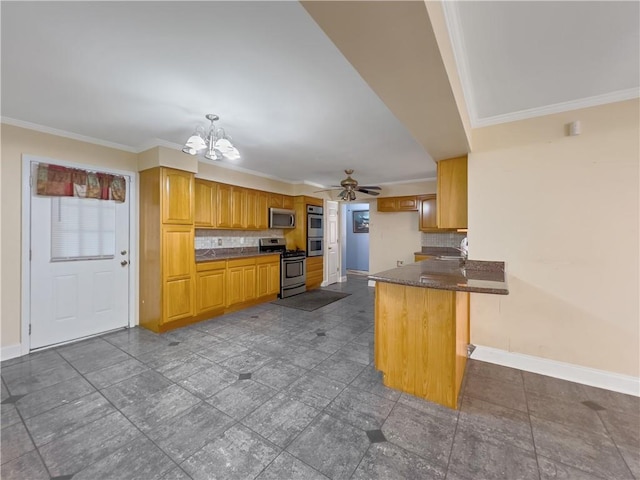 kitchen with backsplash, tile patterned floors, appliances with stainless steel finishes, and kitchen peninsula