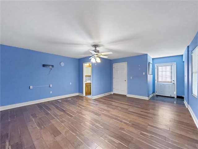 unfurnished living room featuring hardwood / wood-style flooring and ceiling fan